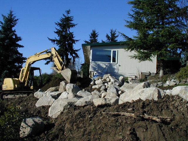 Excavator moving rocks and soil.